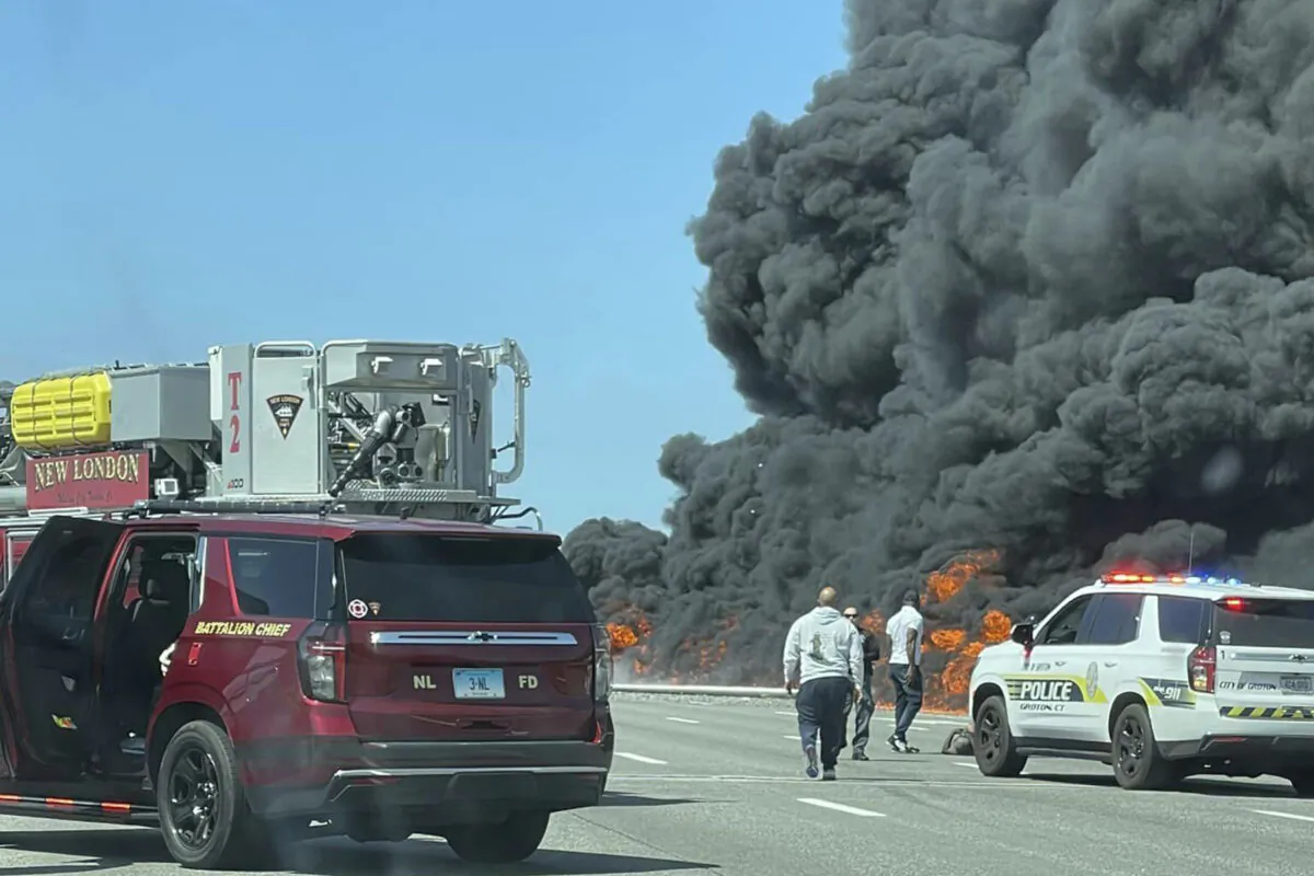 Firefighters and police respond after a crash involving a fuel truck and a car sparked a fire on the Gold Star Bridge between New London and Groton, Conn., on April 21, 2023. (Angelique Feliciano via AP)