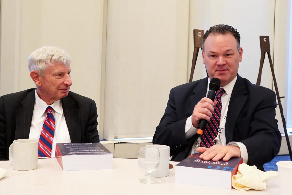 Rick Dearborn (R), executive director of transition for former President Donald Trump, and Donald Devine, former director of the Office of Personnel Management under the Reagan administration, at the Heritage Foundation's leadership summit in National Harbor, Md., on April 20, 2023. (Terri Wu/The Epoch Times)