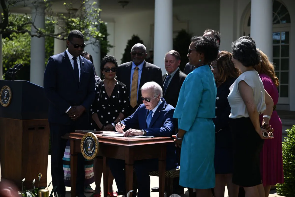 President Joe Biden (C) signs an executive order on new actions to advance environmental justice, in the Rose Garden of the White House in Washington on April 21, 2023. (Brendan Smialowski/AFP via Getty Images)
