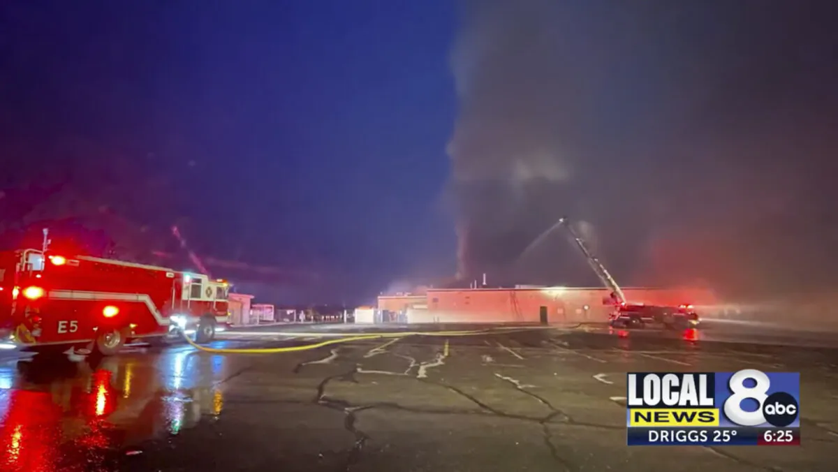 Firefighters work on the scene of an early morning fire at a large high school in Pocatello, Idaho, on April 21, 2023, in a still from video. (KIFI Local News 8 via AP)