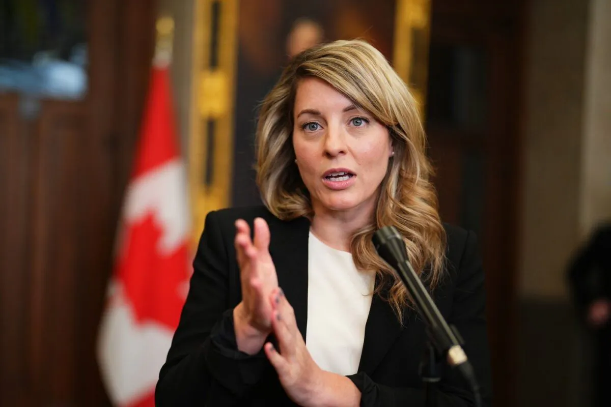 Foreign Affairs Minister Melanie Joly speaks to reporters in the foyer of the House of Commons on Parliament Hill in Ottawa on March 27, 2023. (The Canadian Press/Sean Kilpatrick)

