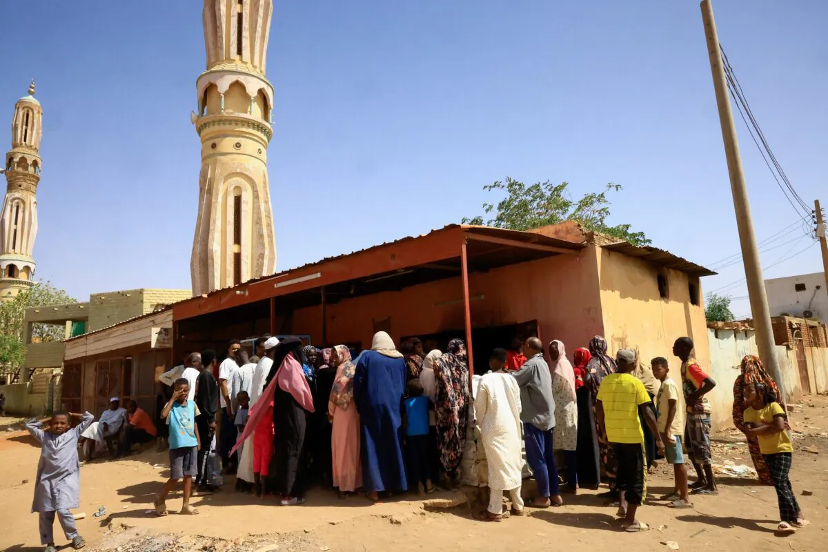 People gather to get bread during clashes between the paramilitary Rapid Support Forces and the army in Khartoum, North Sudan, on April 22, 2023. (Mohamed Nureldin Abdallah/Reuters)