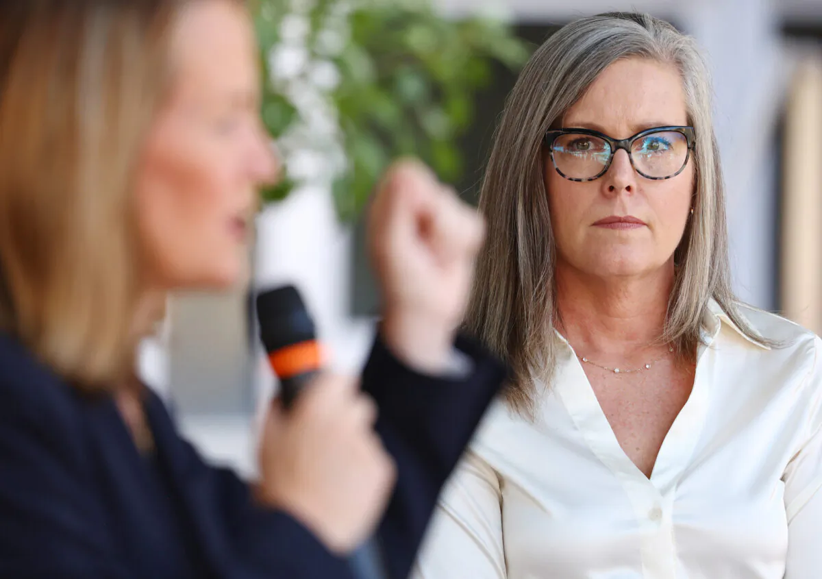 Arizona Secretary of State and Democratic gubernatorial candidate Katie Hobbs (right) looks on as Kris Mayes (left), Democratic candidate for Arizona Attorney General, speaks at a press conference calling for abortion rights outside the Evo A. DeConcini U.S. Courthouse in Tucson, Ariz., on Oct. 7, 2022.(Mario Tama/Getty Images)