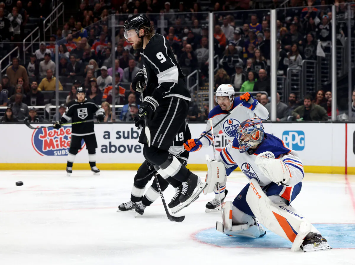 Adrian Kempe (9) of the Los Angeles Kings jumps out of the way of a shot in front of Stuart Skinner (74) of the Edmonton Oilers during a Kings overtime win in Game Three of the First Round of the 2023 Stanley Cup Playoffs at Crypto.com Arena in Los Angeles on April 21, 2023. (Harry How/Getty Images)
