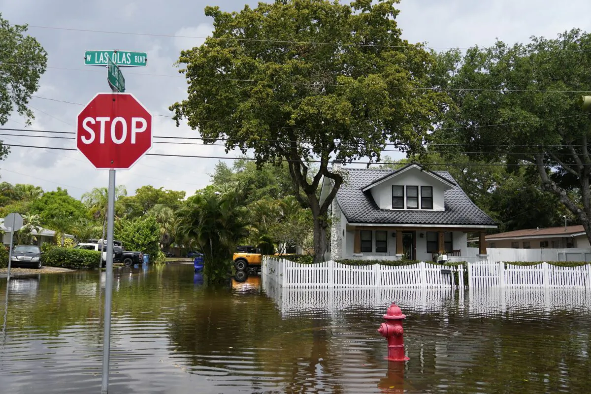 Receding floodwaters surround a home on Las Olas (Spanish for "The Waves") Boulevard in the Sailboat Bend neighborhood in Fort Lauderdale, Fla., on April 13, 2023. (Rebecca Blackwell/AP Photo)