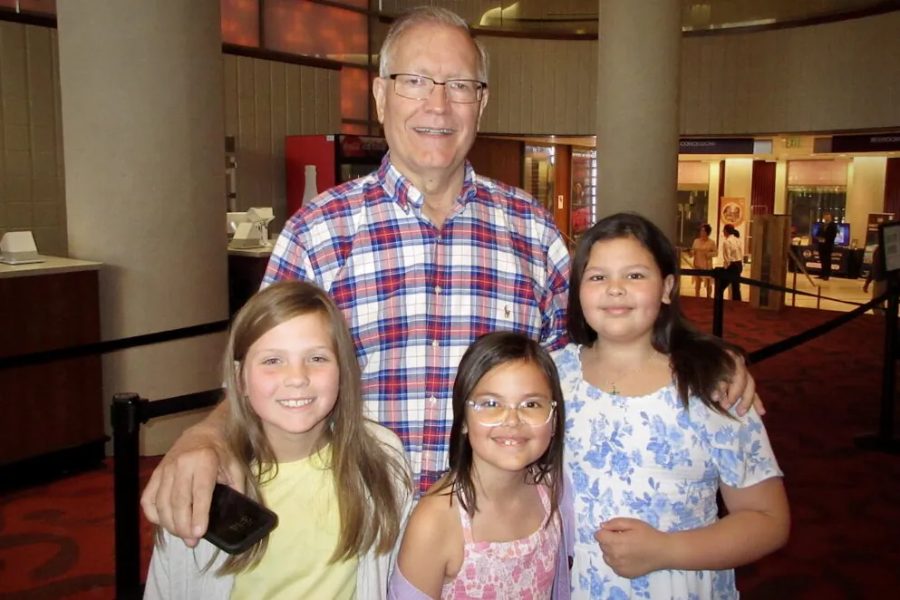 Ron Carlson with 3 of his grandchildren at Shen Yun Performing Arts at the BJCC Concert Hall, in Birmingham, on April 22, 2022. (Roland Ree/The Epoch Times)