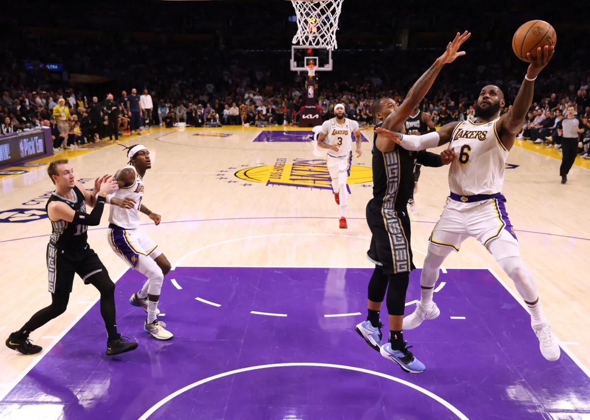 LeBron James (6) of the Los Angeles Lakers scores in front of Xavier Tillman (2) of the Memphis Grizzlies during  the Lakers win in Game Three of the Western Conference First Round Playoffs in Los Angeles on April 22, 2023. (Harry How/Getty Images)