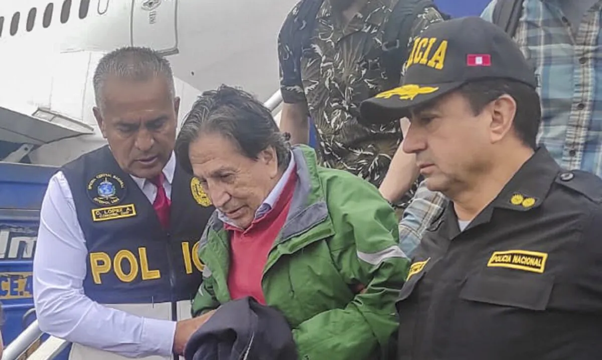 Police officers escort former President Alejandro Toledo upon his arrival, extradited from the United States, to the airport in Lima, Peru, on April 23, 2023. (Peru's National Police via AP)