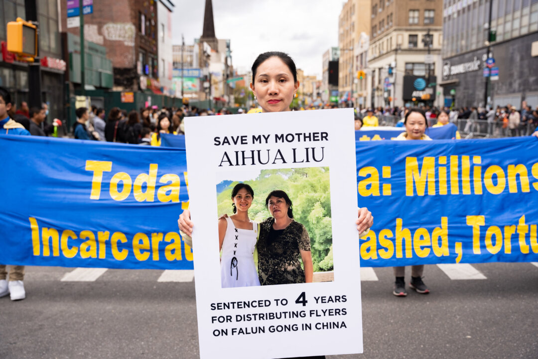 Wang Shanshan participates in a parade to call for an end to the Chinese Communist Party's persecution of their faith in the Flushing neighborhood of Queens, N.Y., on April 23, 2023. (Chung I Ho/The Epoch Times)