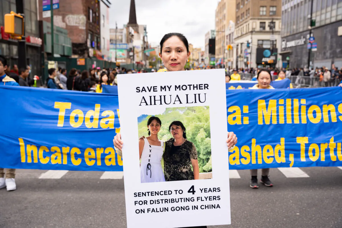 Wang Shanshan participates in a parade to call for an end to the Chinese Communist Party's persecution of their faith in the Flushing neighborhood of Queens, N.Y., on April 23, 2023. (Chung I Ho/The Epoch Times)