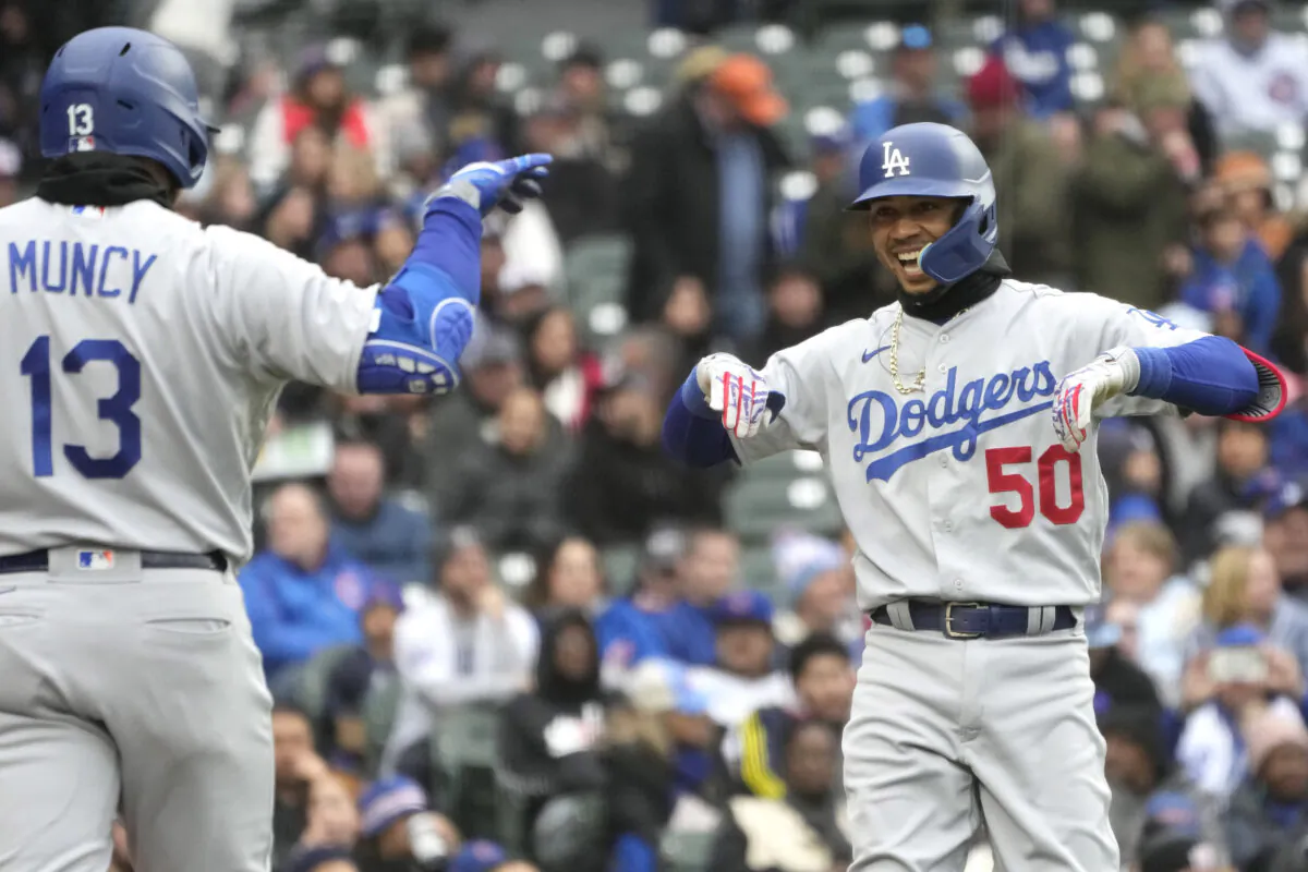 Los Angeles Dodgers' Mookie Betts, right, smiles as he celebrates with Max Muncy after hitting a two-run home run during the third inning of a baseball game in Chicago, on April 23, 2023. (Nam Y. Huh/AP Photo)