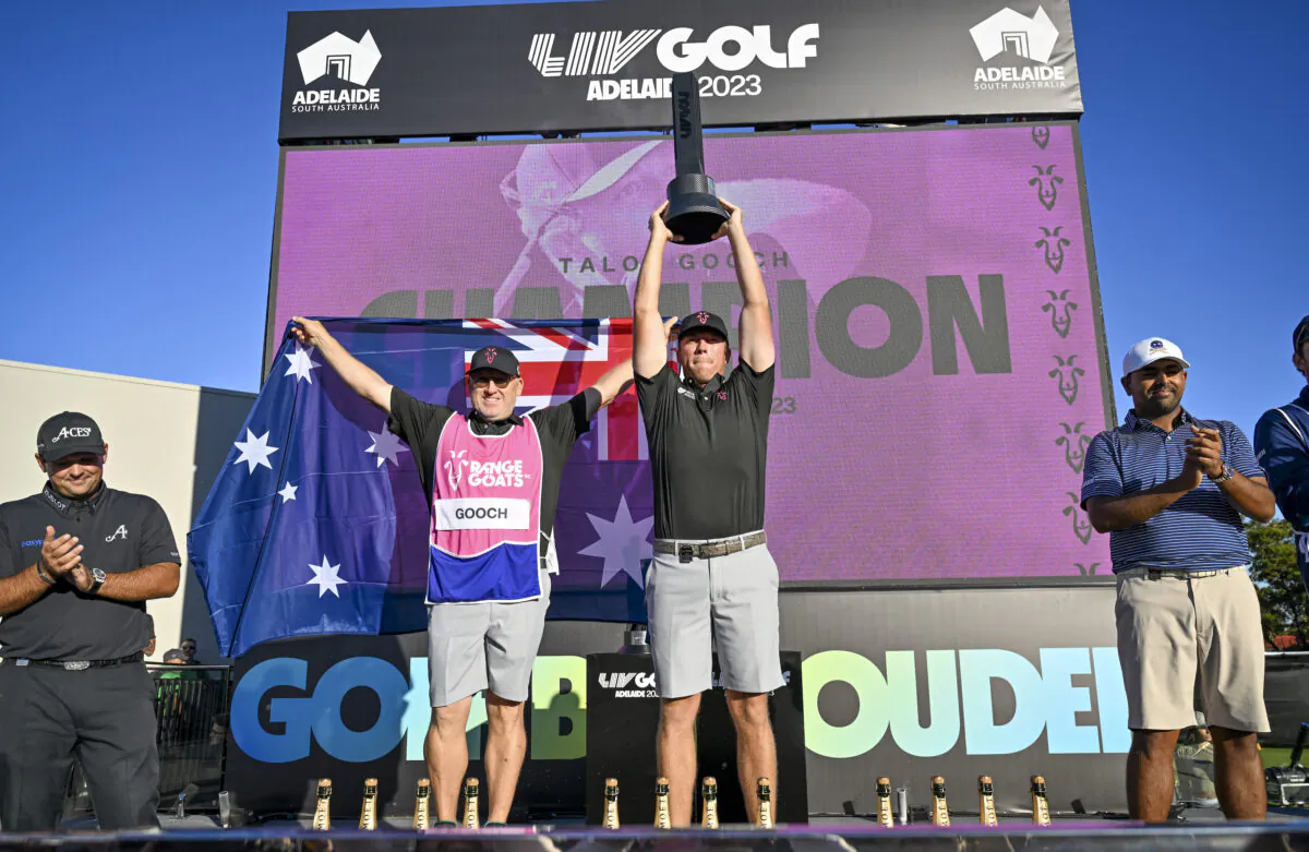 Talor Gooch of the RangeGoats holds up the LIV Golf trophy with his Australian caddie after winning the day three of Liv Golf Adelaide at The Grange Golf Course in Adelaide, Australia on April 23, 2023. (Mark Brake/Getty Images)