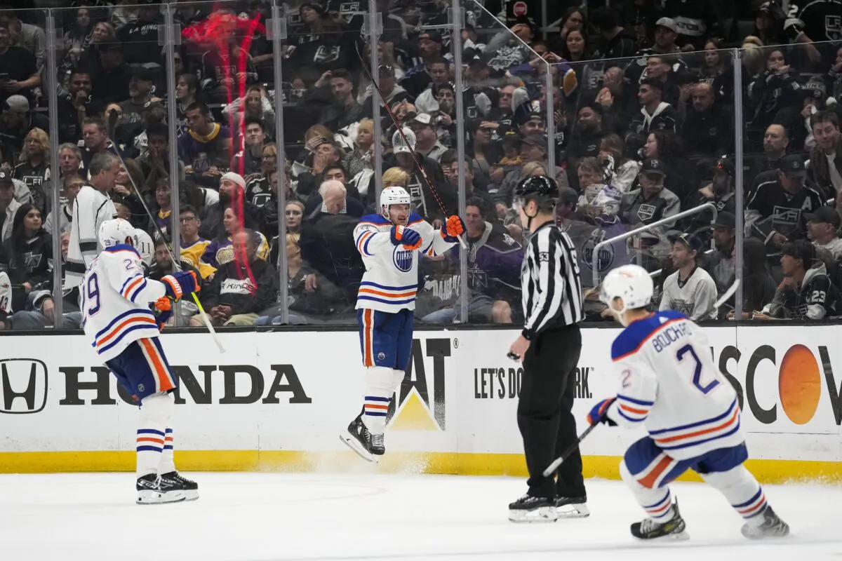 Edmonton Oilers left wing Zach Hyman (18) celebrates with center Leon Draisaitl (29) and defenseman Evan Bouchard (2) after scoring during overtime of Game 4 of an NHL hockey Stanley Cup first-round playoff series hockey game against the Los Angeles Kings in Los Angeles on April 23, 2023. (Ashley Landis/AP Photo)