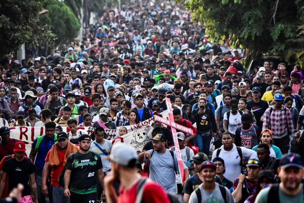 Migrants from Central and South America take part in a caravan attempting to reach the Mexico-US border, while carrying out a viacrucis to protest for the death of 40 migrants in a fire at a detention center in the northern city of Juárez, in Tapachula, Chiapas state, southern Mexico, on April 23, 2023. (Stringer/AFP via Getty Images)