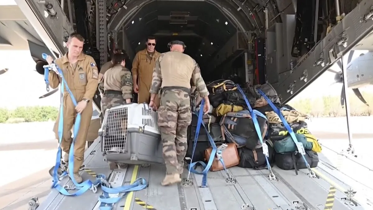 French Armed Forces personnel load belongings of evacuees onto a plane at the airport in Khartoum, Sudan, on April 23, 2023. (French Armed Forces via AP)