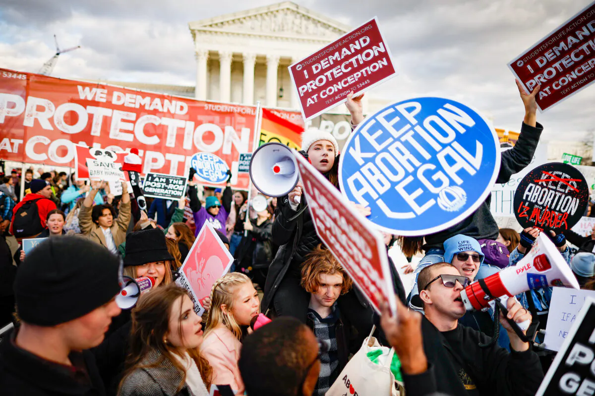 Pro-life and pro-abortion activists hold signs with opposing views during the 50th Annual March for Life rally in front of the U.S. Supreme Court in Washington on Jan. 20, 2023. (Chip Somodevilla/Getty Images)