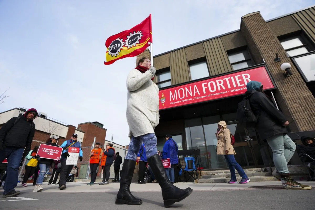 PSAC workers and supporters picket in front of President of the Treasury Board Mona Fortier's office in Ottawa on April 21, 2023. (The Canadian Press/Sean Kilpatrick)