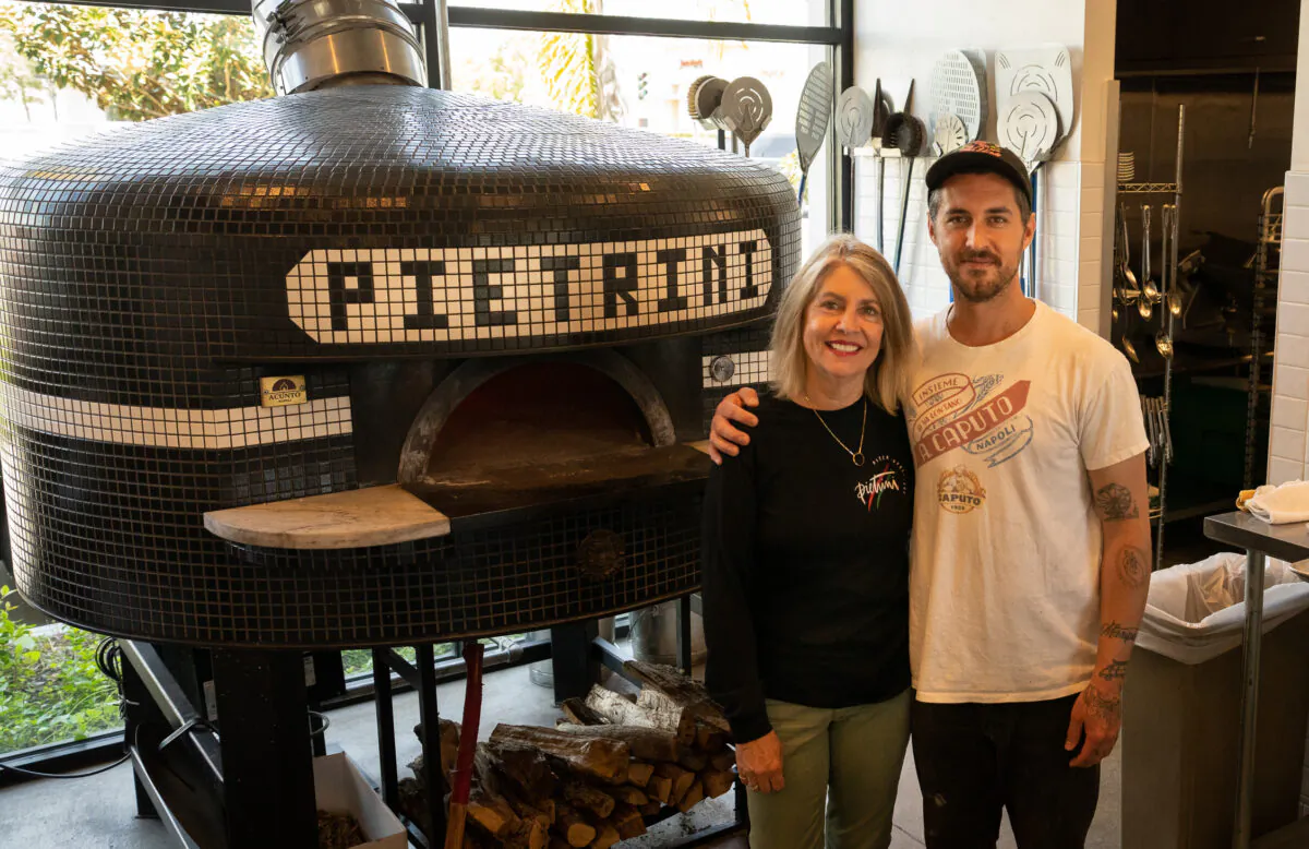 Pietrini Pizza Owner Blair Pietrini and son Head Pizza Chef Landon Pietrini stand at Pietrini Pizza in Los Alamitos, Calif., on April 20, 2023. (John Fredricks/The Epoch Times)