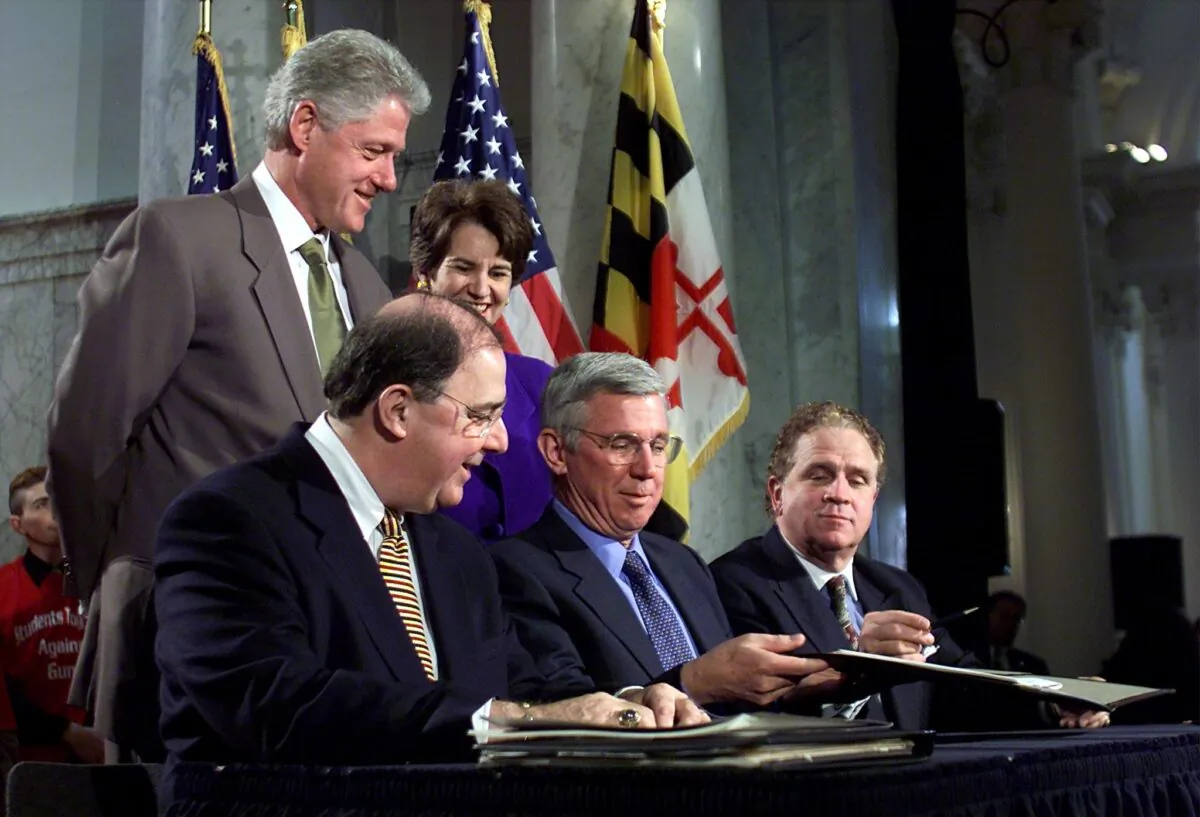 U.S. President Bill Clinton (L) witnesses the bill signing with Casper Taylor (2ndL), the speaker of the Maryland House, Maryland Gov. Parris Glendening (C), Mike Miller (R), the Maryland State Senate president and Lt. Gov. Kathleen Kennedy Townsend (rear), of the Responsible Gun Safety Act of 2000 bill signing at the State Assembly Lobby of the Maryland State Capitol in Annapolis, Maryland on April 11, 2000. (Stephen Jaffe/AFP via Getty Images)