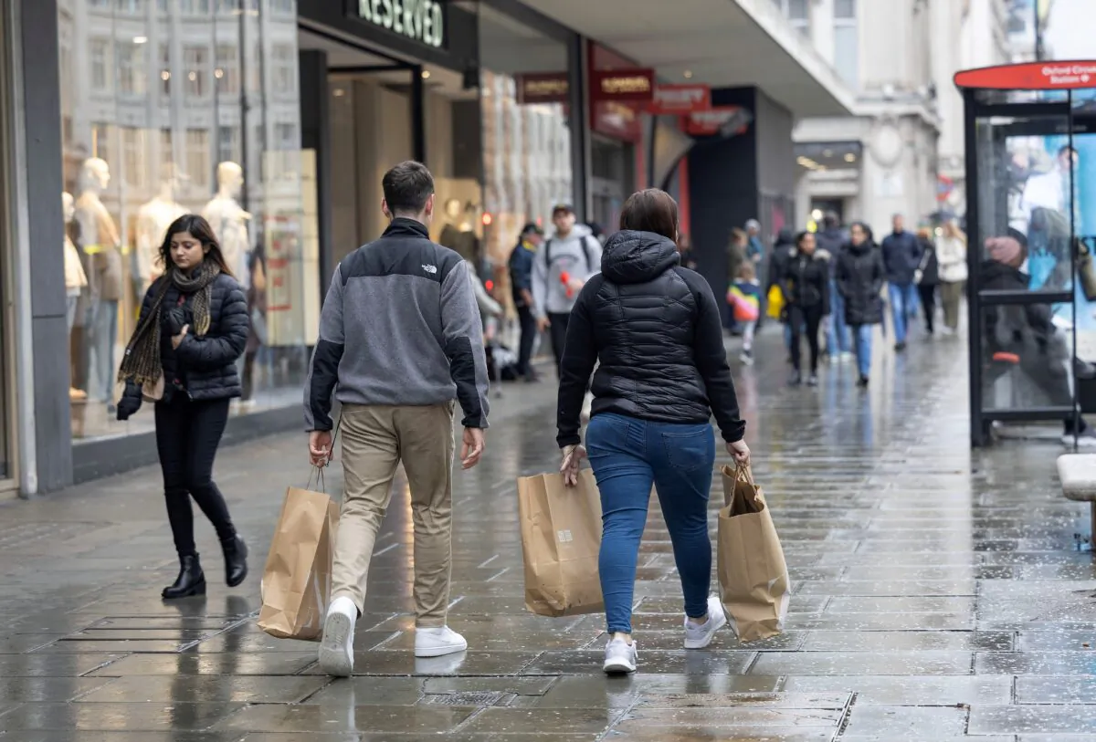 People shop on Oxford Street in London on April 10, 2023. (Anna Gordon/Reuters)