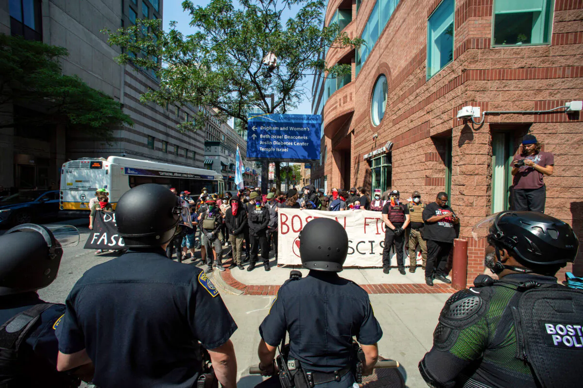 Police face pro-transgender protesters outside of Boston Children's Hospital in Boston on Sept. 18, 2022. (Joseph Prezioso/AFP via Getty Images)