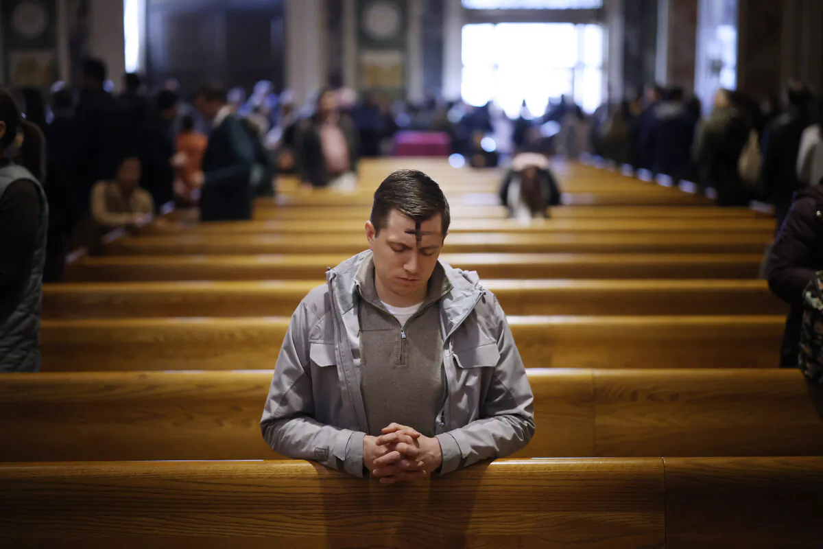 With a cross of ash on his forehead, a man prays following an Ash Wednesday Mass at the Cathedral of St. Matthew the Apostle in Washington, on Feb. 22, 2023. For Christians, Ash Wednesday begins Lent, the annual season of penance preceding Easter. (Chip Somodevilla/Getty Images)