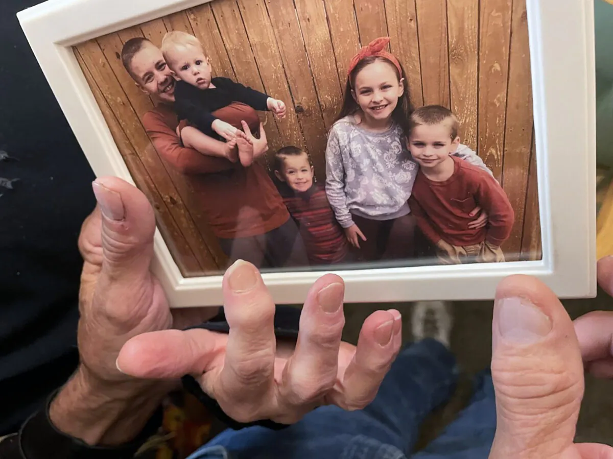 (L–R) Brian Anthony Nelson II, Kurgan Nelson, Ragnar Nelson, Brantley Nelson, and Vegeta Nelson in a framed photograph in their grandparents apartment in Tulsa, Okla., on Oct. 28, 2022. (Andrea Eger/Tulsa World via AP)