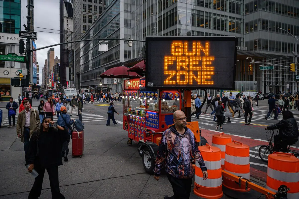 Pedestrians pass a ‘gun free zone’ sign in New York city on Oct. 13, 2022. (Ed Jones/AFP via Getty Images)
