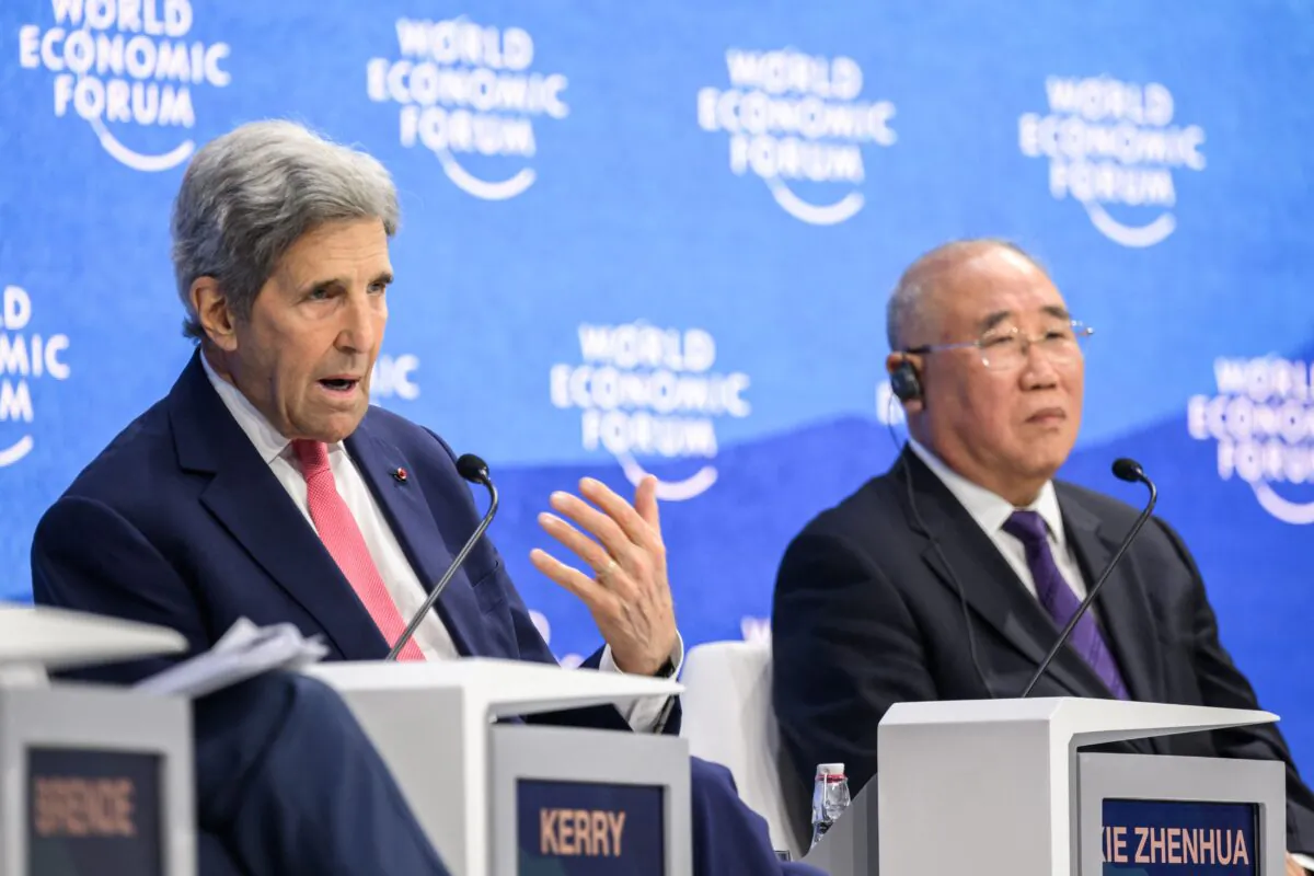 U.S. climate envoy John Kerry (L) gestures as he speaks next to China's special climate envoy, Xie Zhenhua, during a session at the World Economic Forum annual meeting in Davos on May 24, 2022. (Fabrice Coffrini/AFP via Getty Images)