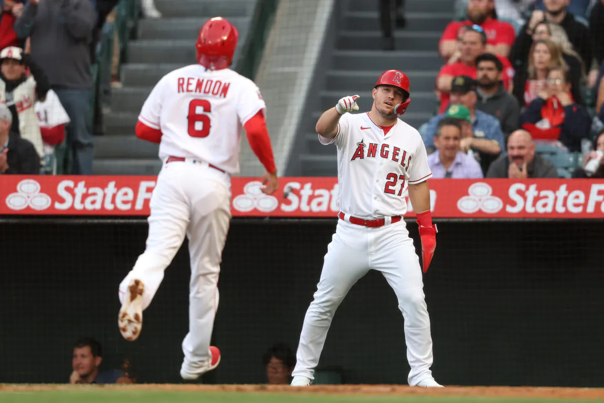 Mike Trout (27) of the Los Angeles Angels celebrates with Anthony Rendon (6) after scoring off of a triple from Brandon Drury (23) during the first inning against the Oakland Athletics at Angel Stadium of Anaheim in Anaheim, Calif., on April 25, 2023. (Michael Owens/Getty Images)

