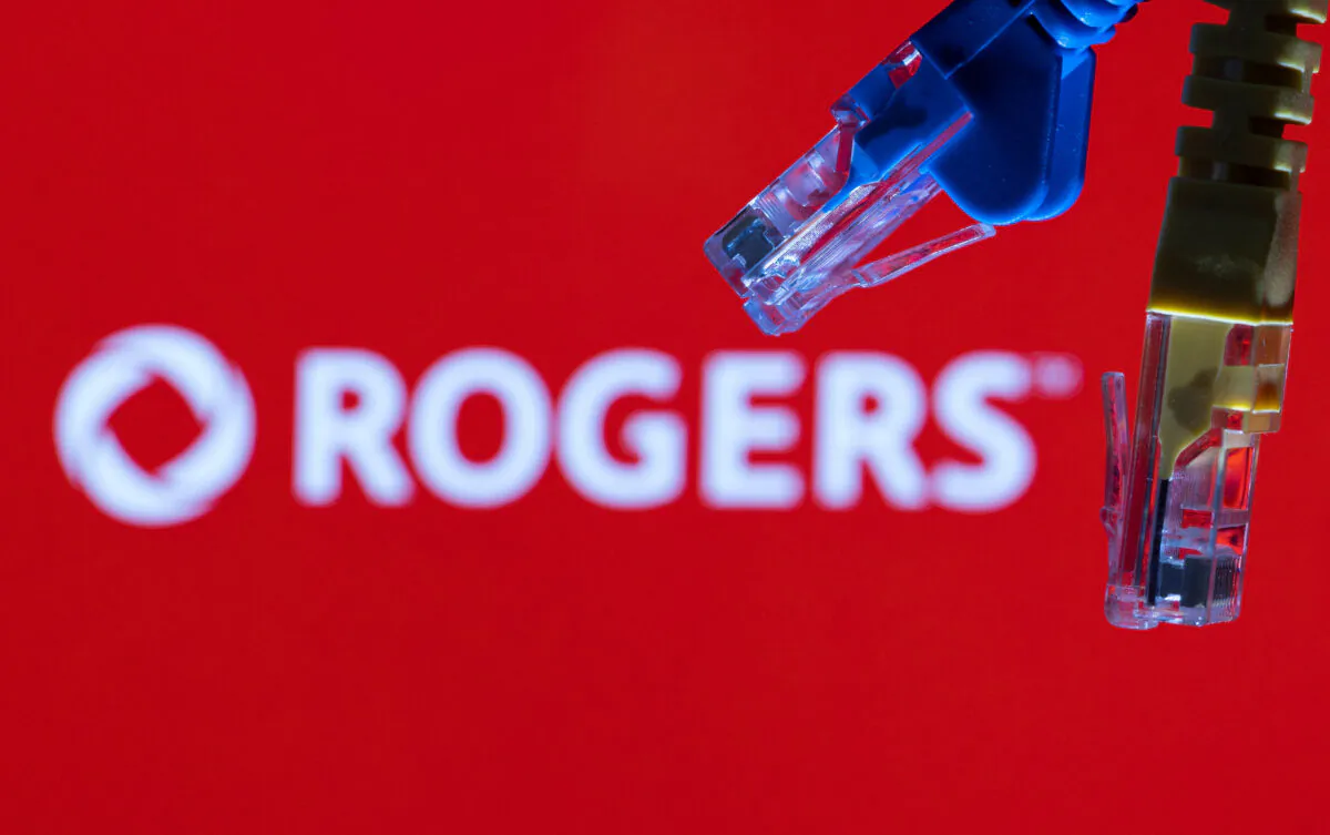 Ethernet cables are seen in front of Rogers Communications logo in an illustration taken on July 8, 2022. (Dado Ruvic/Illustrations/Reuters)
