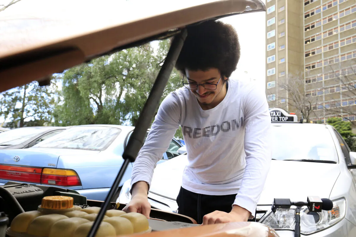 A Melbourne resident tries to starts his car in Melbourne, Australia, on July 19, 2020. (Darrian Traynor/Getty Images)