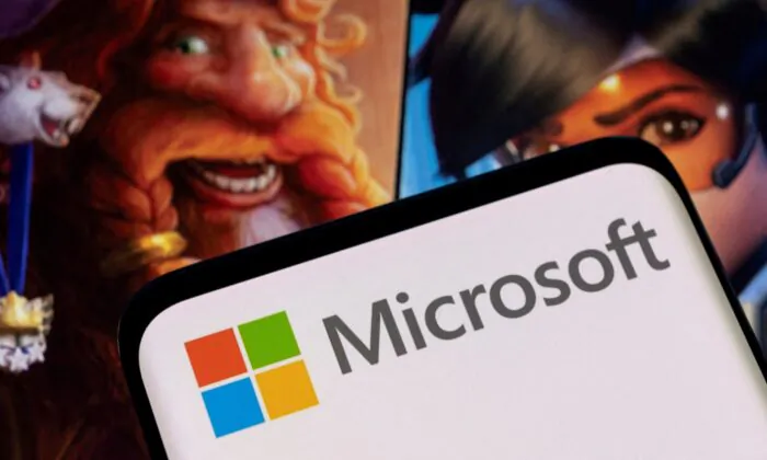 Microsoft logo on a smartphone placed on displayed Activision Blizzard's games characters, on Jan. 18, 2022. (Dado Ruvic/Reuters)