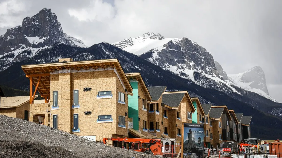 Mountains loom behind homes under construction in Canmore, Alta., on April 24, 2023. (Jeff McIntosh/The Canadian Press)