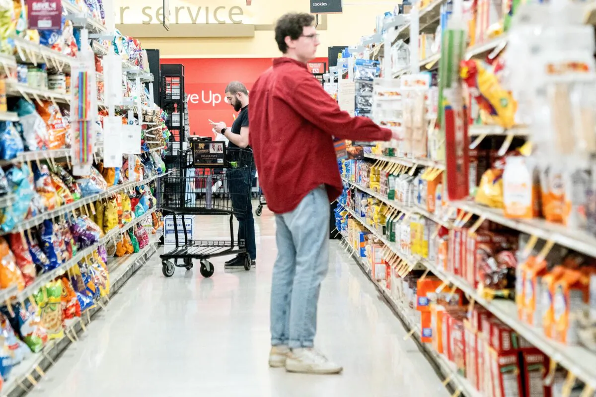 Shoppers look at items displayed at a grocery store in Washington, on Feb. 15, 2023. (Photo by STEFANI REYNOLDS/AFP via Getty Images)