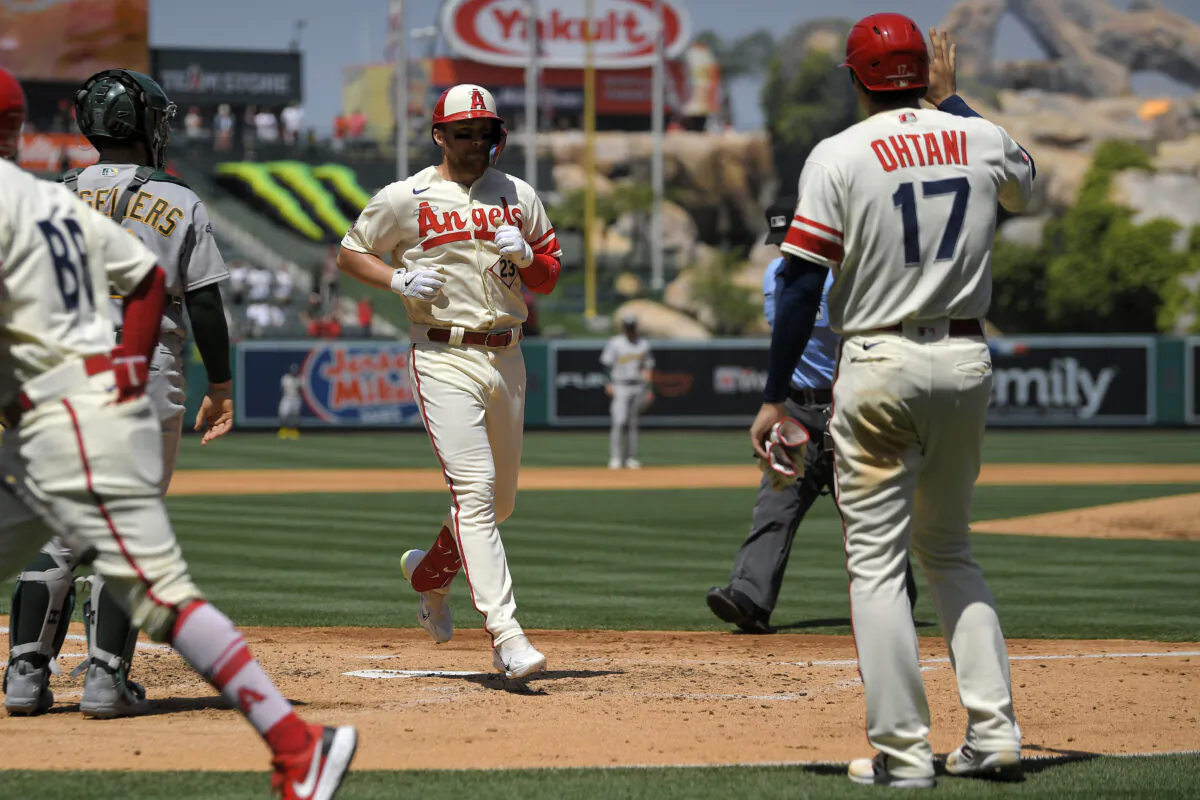 Los Angeles Angels' Brandon Drury, center, scores after hitting a three-run home run as Shohei Ohtani, right, waits to congratulate him while Oakland Athletics catcher Shea Langeliers stands at the plate during the third inning of a baseball game in Anaheim, Calif., on April 27, 2023. (Mark J. Terrill/AP Photo)