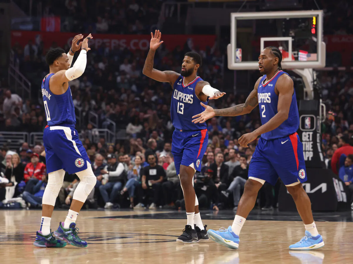 Kawhi Leonard (2), Paul George (13) and Russell Westbrook (0) of the LA Clippers celebrate after a timeout during the first half against the Minnesota Timberwolves in Los Angeles, on Feb. 28, 2023. (Harry How/Getty Images)