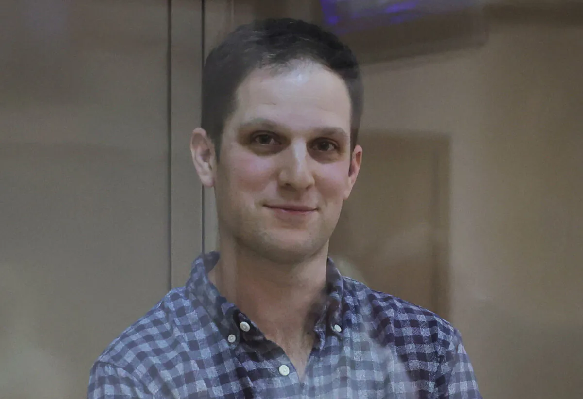 Wall Street Journal reporter Evan Gershkovich, who was detained in March while on a reporting trip and charged with espionage, stands behind a glass wall of an enclosure for defendants before a court hearing to consider an appeal against his detention, in Moscow on April 18, 2023. (Evgenia Novozhenina/Reuters)