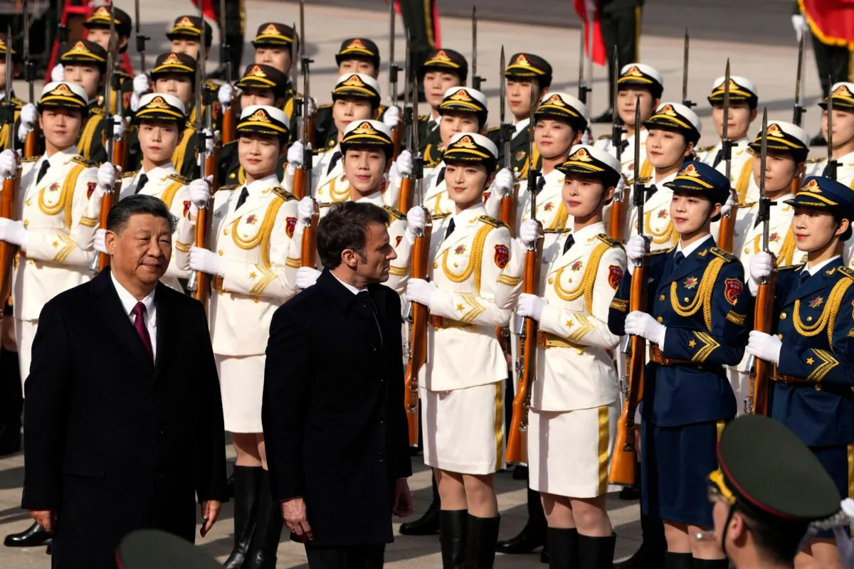French President Emmanuel Macron inspects an honor guard with Chinese leader Xi Jinping during a welcome ceremony April 6, 2023 outside the Great Hall of the People in Beijing. (Ng Han Guan/Pool/Getty Images)