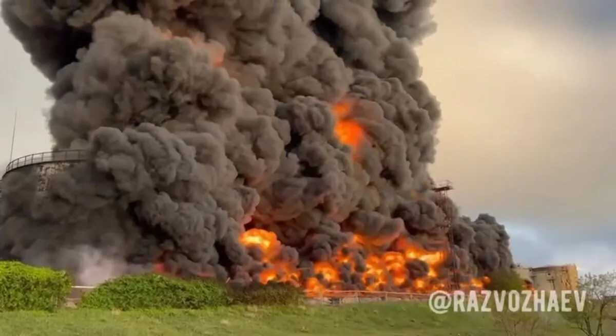 Smoke and flames rise from a burning fuel tank in Sevastopol, Crimea, in this handout photo taken from video released by the Governor of Sevastopol Mikhail Razvozhaev on April 29, 2023. (Sevastopol Governor Mikhail Razvozhaev telegram channel via AP)