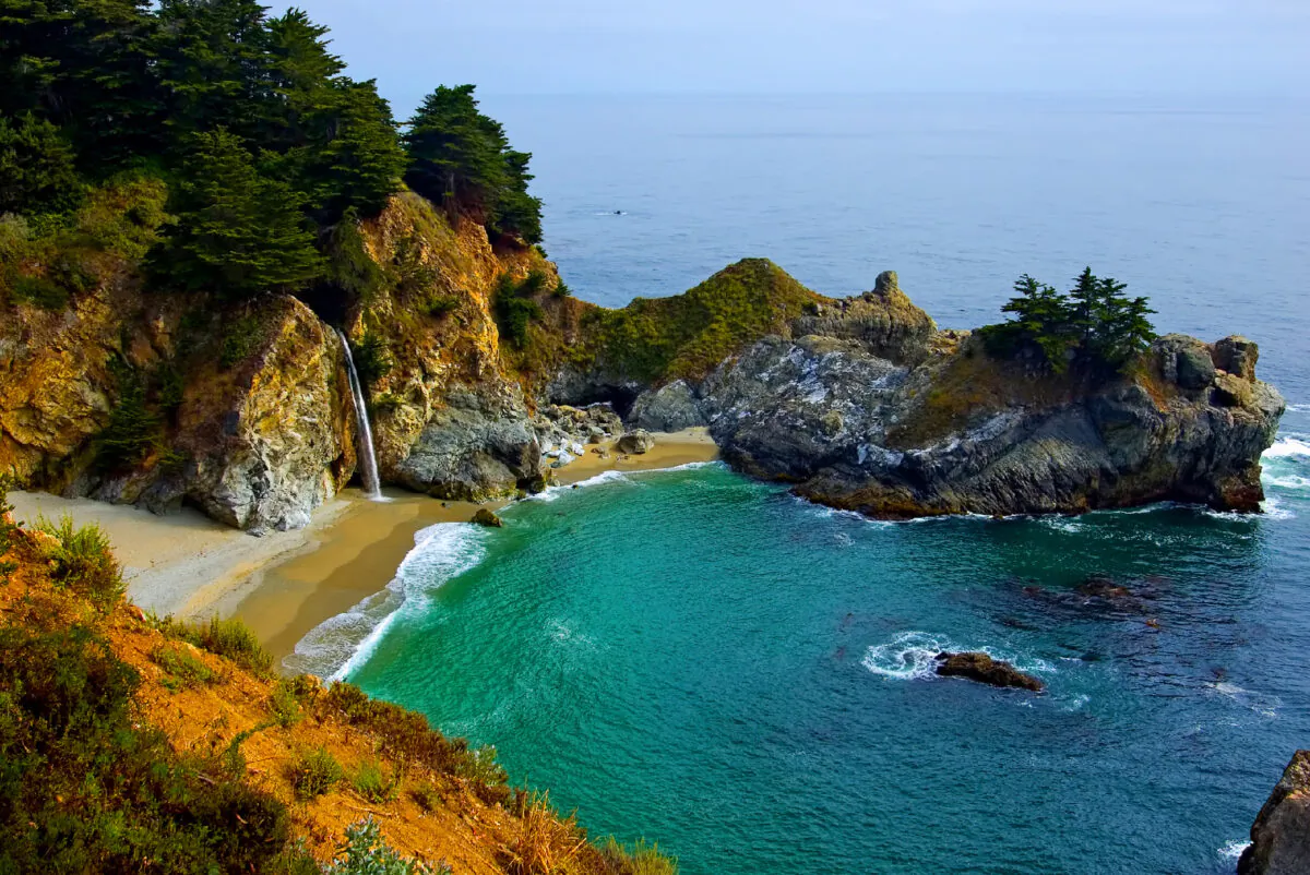 McWay Falls in the Julia Pfeiffer Burns State Park in California, spills over copper-colored cliffs onto a Pacific Ocean beach. (Photo courtesy of Photoquest/Dreamstime.com)