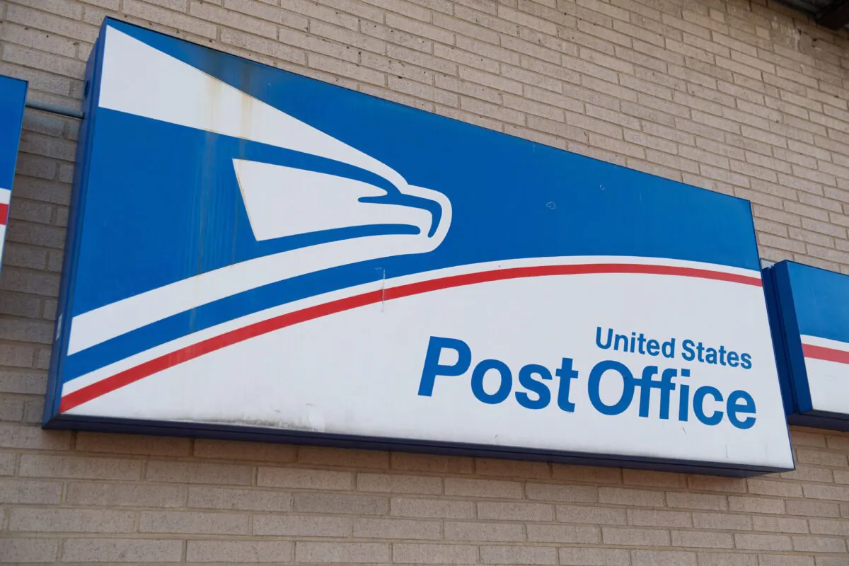 A sign is seen outside a United States Postal Service (USPS) post office location in Washington,on April 16, 2020. (Saul Loeb/AFP via Getty Images)