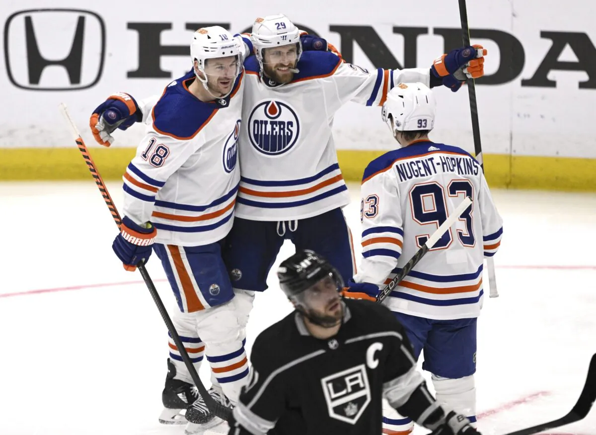 Edmonton Oilers' Leon Draisaitl (29) celebrates with Zach Hyman (18) and Ryan Nugent-Hopkins after his goal, as Los Angeles Kings' Anze Kopitar skates past during the second period in Game 6 of an NHL hockey Stanley Cup first-round playoff series in Los Angeles on April 29, 2023. (Keith Birmingham/The Orange County Register via AP)