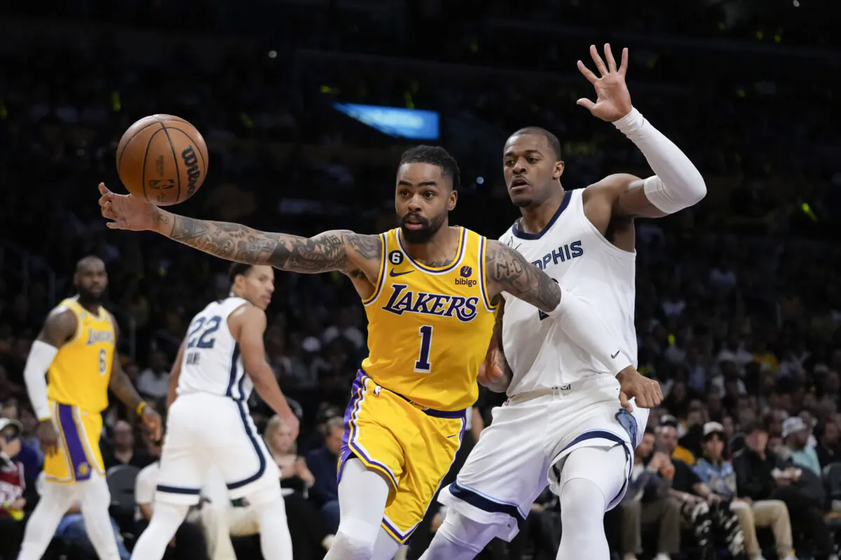 Los Angeles Lakers' D'Angelo Russell (1) is defended by Memphis Grizzlies' Xavier Tillman (2) during the first half in Game 6 of a first-round NBA basketball playoff series in Los Angeles on April 28, 2023. (Jae C. Hong/AP Photo)