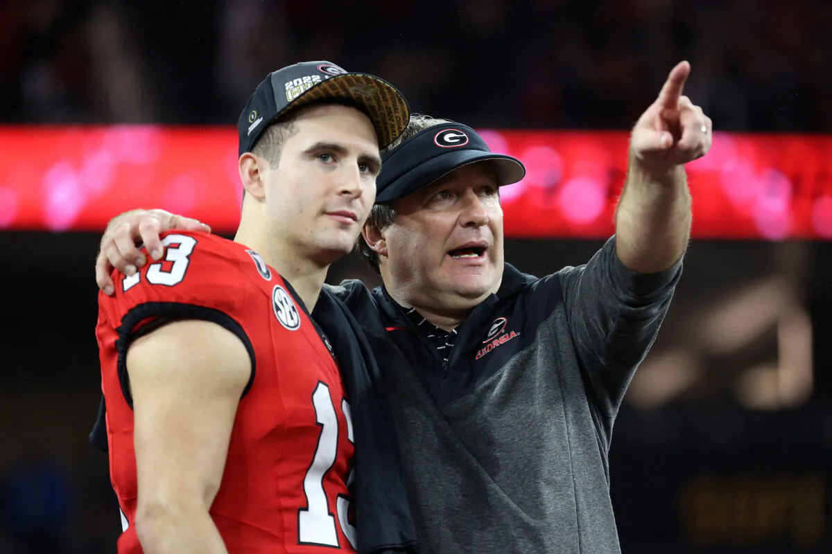 Stetson Bennett (13) celebrates with Head coach Kirby Smart of the Georgia Bulldogs after defeating the TCU Horned Frogs, 65–7, in the College Football Playoff National Championship game at SoFi Stadium in Inglewood, Calif.,  on Jan. 9, 2023. (Ezra Shaw/Getty Images)