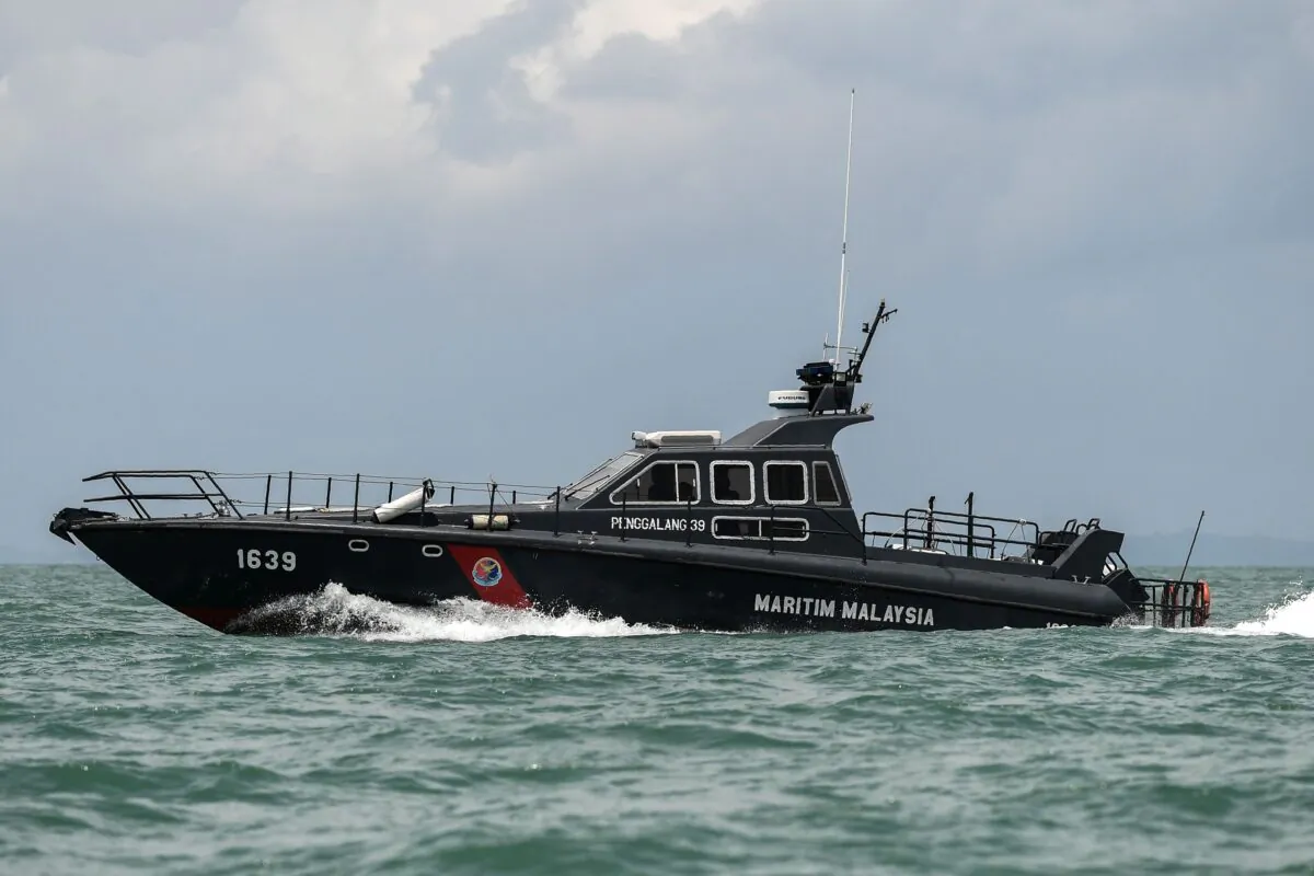 A Malaysian Maritime Enforcement Agency boat takes part in the rescue operation for missing sailors from the USS John S. McCain guided-missile destroyer off the Johor coast of Malaysia on Aug. 24, 2017. (Mohd Rasfan/AFP via Getty Images)