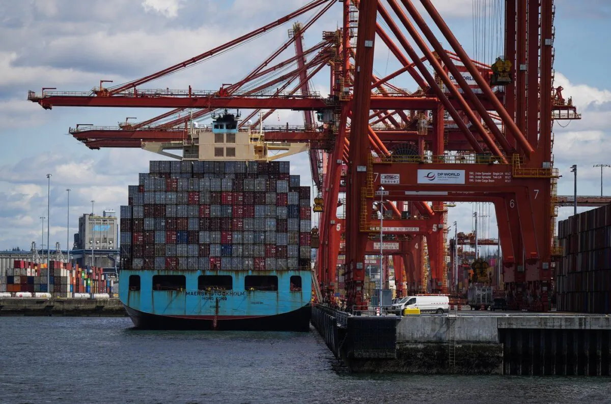 Cargo containers are unloaded from the Maersk Stockholm ship with gantry cranes while docked in Vancouver on April 25, 2023. (The Canadian Press/Darryl Dyck)

