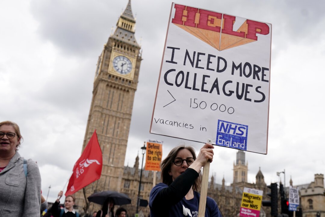 NHS workers take part in a march from St. Thomas's Hospital to Trafalgar Square, as members of the Royal College of Nursing and the Unite union continue their strike action in a dispute over pay, in London, on May 1, 2023. (Jordan Pettitt/PA Media)