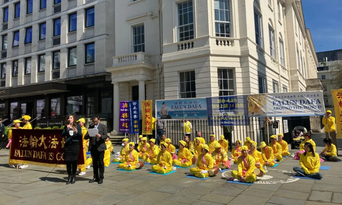 Representatives of the UK Falun Dafa Association read support letters from politicians at a rally for the 24th anniversary of a peaceful protest, in London on April 29, 2023. (Zoe Wang/The Epoch Times)