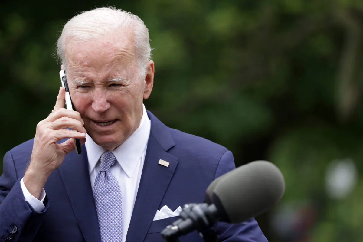 U.S. President Joe Biden talks on a cell phone in Washington on May 1, 2023. (Alex Wong/Getty Images)